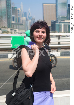 A woman in a great mood happily strolls around her favorite city 123583578