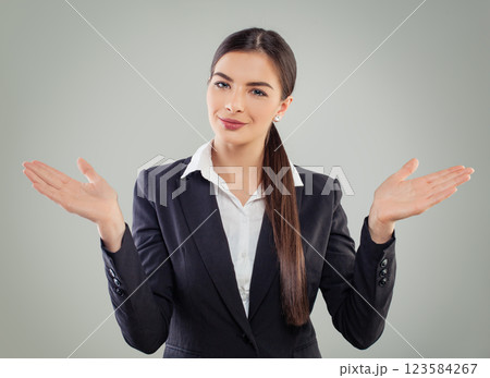 Smiling business woman looking at camera, smiling and holding empty palm hand on white background Smiling business woman looking at camera, smiling and holding empty palm hand on white background 123584267