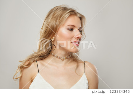 Stylish young blond female model with clear skin, soft make-up and healthy hair 123584346