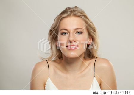 Cute smiling woman. Female model with blond hairstyle and clean skin 123584348