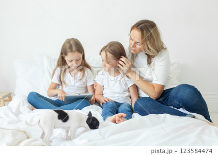 Cute family relaxing on the couch together at home Cute family relaxing on the couch together at home 123584474