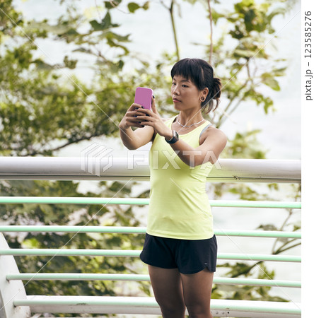 young asian woman taking a selfie outdoors young asian woman taking a selfie outdoors 123585276