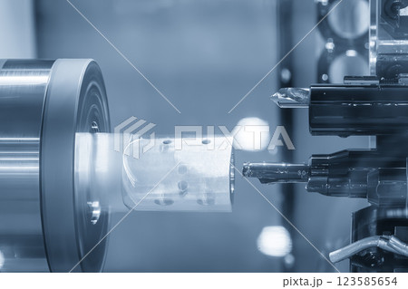 The  multi tasking CNC lathe machine swiss type bore cutting the metal tube parts. 123585654