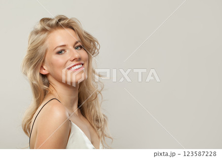 Attractive blond woman with cute smile looking at camera. Beauty young adult person portrait 123587228