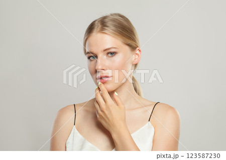 Pensive blond model woman portrait. Beautiful face with healthy clear skin, long shiny hair 123587230