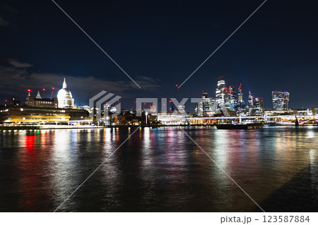 London city skyline at night with Thames River reflections and illuminated skyscrapers London city skyline at night with Thames River reflections and illuminated skyscrapers 123587884