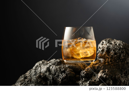 Whiskey with ice on a grey stone. Whiskey with ice on a grey stone. 123588800