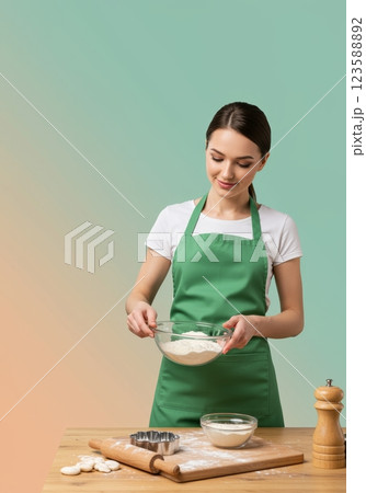 Woman Baking in Green Apron Home Kitchen Culinary Art Natural Light Close-Up Passion for Cooking 123588892