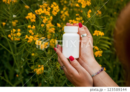 Female hands hold a white jar against Female hands hold a white jar against 123589144