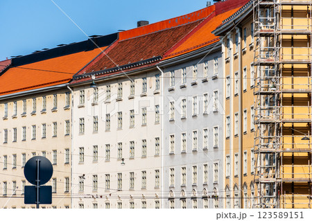 Colorful Helsinki buildings with red roofs on a bright day showcases the city's architecture. Colorful Helsinki buildings with red roofs on a bright day showcases the city's architecture. 123589151