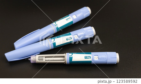 Ozempic Insulin injection pen on a dark background for diabetics and weight loss. 123589592
