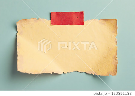 A red pin is stuck in a piece of paper A red pin is stuck in a piece of paper 123591158