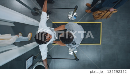 Diverse People Passing Through X-ray Metal Detector Scanner, Airport Worker Checking Passengers 123592352