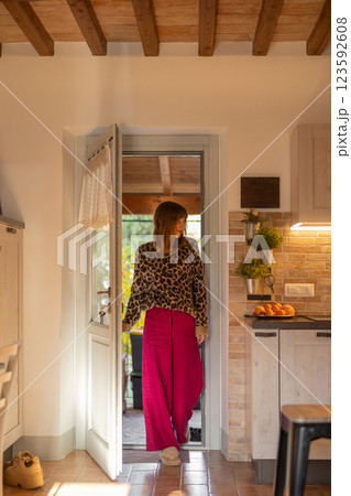 Stylish Woman in Rustic Kitchen 123592608