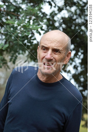Uncomfortable Elderly Man Cannot Walk In Natural Park Under Trees 123594188