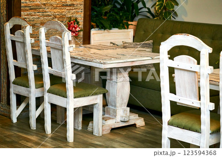 Small retro wooden table in a cafe with massive chairs 123594368