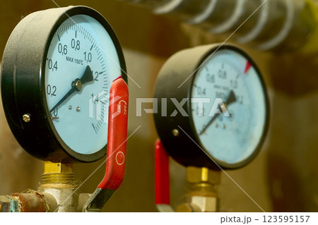 Two sensors of hot water temperature in a basement plumbing system 123595157