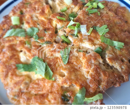 The omelet is crispy on the outside and soft on the inside. 123598978