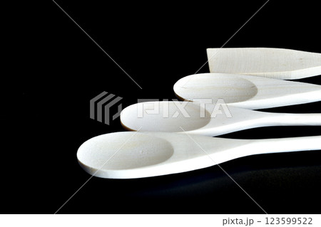 White wooden spoons lie in a row. White wooden spoons lie in a row. 123599522
