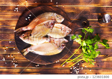Uncooked Raw fish on board. wooden background. Uncooked Raw fish on board. wooden background. 123601800