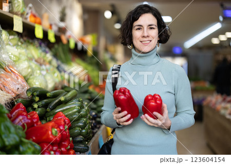 European woman chooses bell peppers 123604154