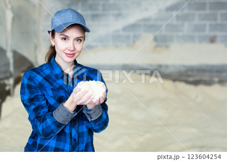 Portrait of woman farmer with handful of fodder Portrait of woman farmer with handful of fodder 123604254