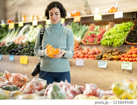 Woman choosing pumpkin in supermarket 123604500