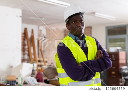 Portrait of man builder standing in construction site Portrait of man builder standing in construction site 123604559