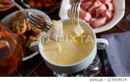 Cheese fondue with bread and snacks Cheese fondue with bread and snacks 123604614