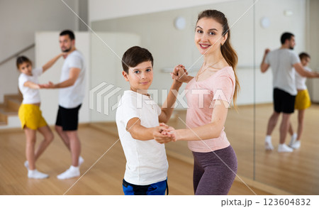 Mother dancing with her son during group family training 123604832
