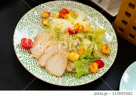 Just cooked Caesar salad served on white plate 123605082