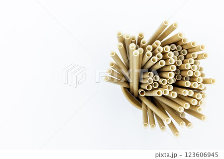 Paper cups and paper straws on white background, Accessories for drinking outdoors, Ecology recycling eco friendly, Eco friendly reusable paper straws, Kraft paper straw for drinking coffee or tea. 123606945