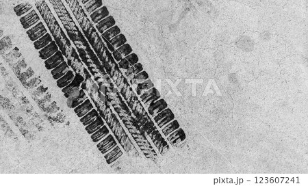 Black tire marks on road, Black rubber tire marks and tread marks, Tire trace track wheels texture and background, Auto tire tread grunge, Car wheel tyre tread track black tyre print, Top view. 123607241