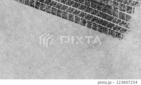 Black tire marks on road, Black rubber tire marks and tread marks, Tire trace track wheels texture and background, Auto tire tread grunge, Car wheel tyre tread track black tyre print, Top view. 123607254