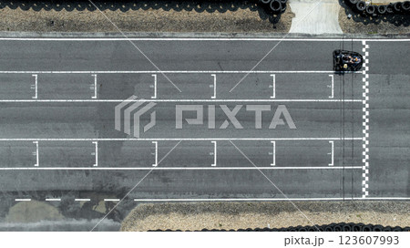 Aerial view Go kart racer cross the finish line, Go kart at circuit start and finish line, Top view race go kart track. Aerial view Go kart racer cross the finish line, Go kart at circuit start and finish line, Top view race go kart track. 123607993