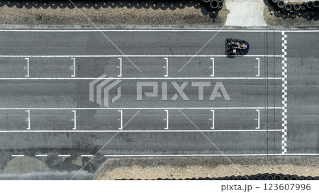 Aerial view Go kart racer cross the finish line, Go kart at circuit start and finish line, Top view race go kart track. 123607996