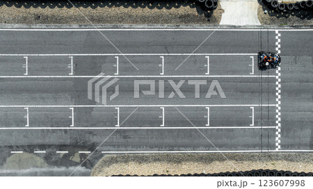 Aerial view Go kart racer cross the finish line, Go kart at circuit start and finish line, Top view race go kart track. 123607998