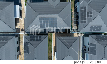 Solar panels being installed on home building rooftop, Solar panels installed on new houses being built, Sustainable homes with solar panel rooftop being built, Aerial view Solar panels being installed on home building rooftop, Solar panels installed on new houses being built, Sustainable homes with solar panel rooftop being built, Aerial view 123608036