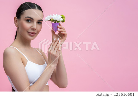 Female holding silicone container representing alternative menstrual care and hygiene 123610601