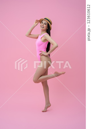 Enjoyed pretty young woman in pink bodysuit and straw hat Enjoyed pretty young woman in pink bodysuit and straw hat 123610612