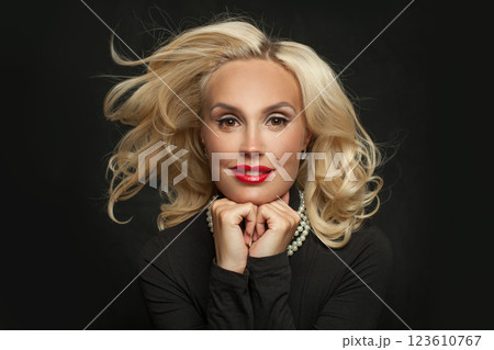 Glamorous blond woman with makeup and perfect wavy hair posing Glamorous blond woman with makeup and perfect wavy hair posing 123610767