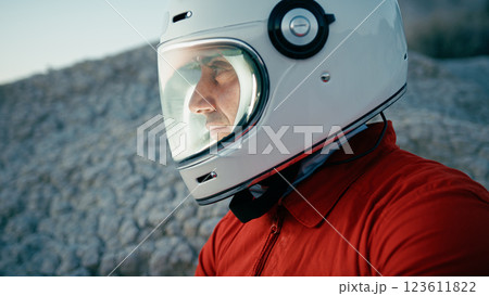 Astronaut With Helmet Looks Around And Opens Helmet Visor In New Planet Astronaut With Helmet Looks Around And Opens Helmet Visor In New Planet 123611822