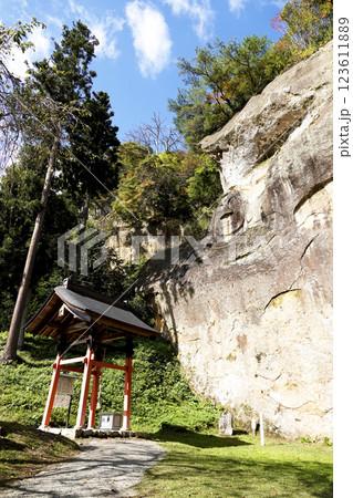 岸壁に顔だけが残った岩面大仏(顔面大仏)とその正面にある本坪鈴、さい銭箱がある礼堂 岸壁に顔だけが残った岩面大仏(顔面大仏)とその正面にある本坪鈴、さい銭箱がある礼堂 123611889