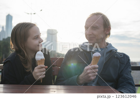 Father and young daughter resting on caffee, eating ice cream at sunny day. Father and young daughter resting on caffee, eating ice cream at sunny day. 123612046