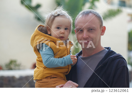 Cheerful baby girl and father walking outdoors 123612061