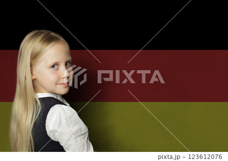 Cute young child girl on German flag background. Education and study language in Germany concept Cute young child girl on German flag background. Education and study language in Germany concept 123612076