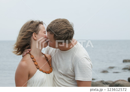 Kissing couple. Man and woman in love near sea outdoors 123612572