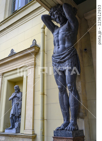 19th century sculpture of Atlantean holding the portico of the Hermitage in St. Petersburg, Russia 123612933