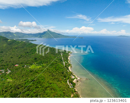 Aerial view of Island with beach and turquoise water and corals. San Agustin, Tablas Island. Romblon, Philippines. Aerial view of Island with beach and turquoise water and corals. San Agustin, Tablas Island. Romblon, Philippines. 123613401