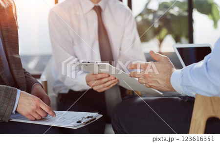 Man exchanging contract or document for signing 123616351
